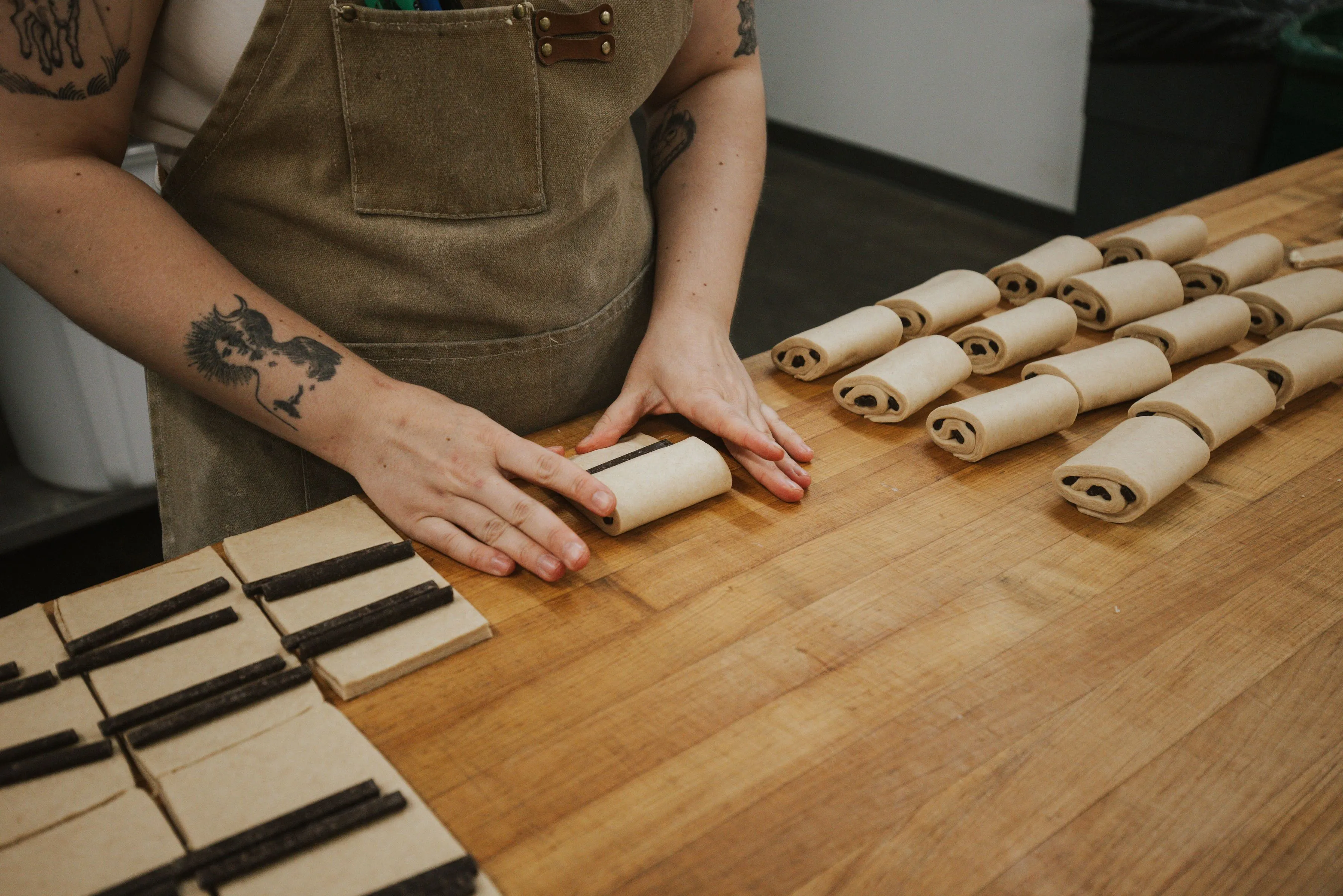 A baker rolling chocolatines.